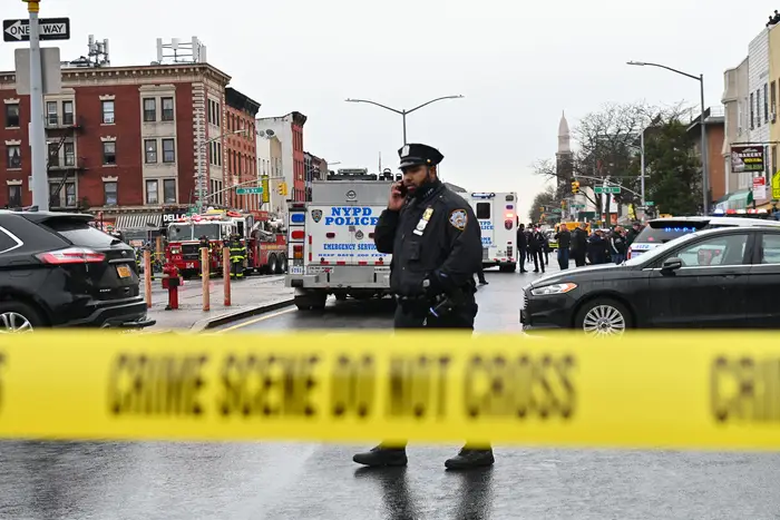 An NYPD officer on scene after a shooting in Sunset Park, Brooklyn.